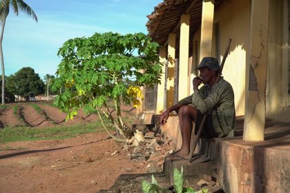 Homem em uma varanda tradicional de área rural de Pernambuco, sentado e descansando.